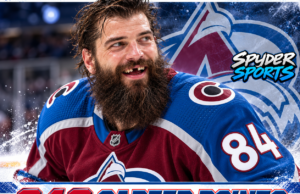 Brent Burns wearing Colorado Avalanche No. 84 jersey, celebrating 948 career points and tying Chris Chelios for 10th all-time among NHL defensemen.